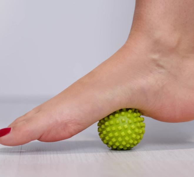 foot steps on massage ball to relieve plantar fasciitis